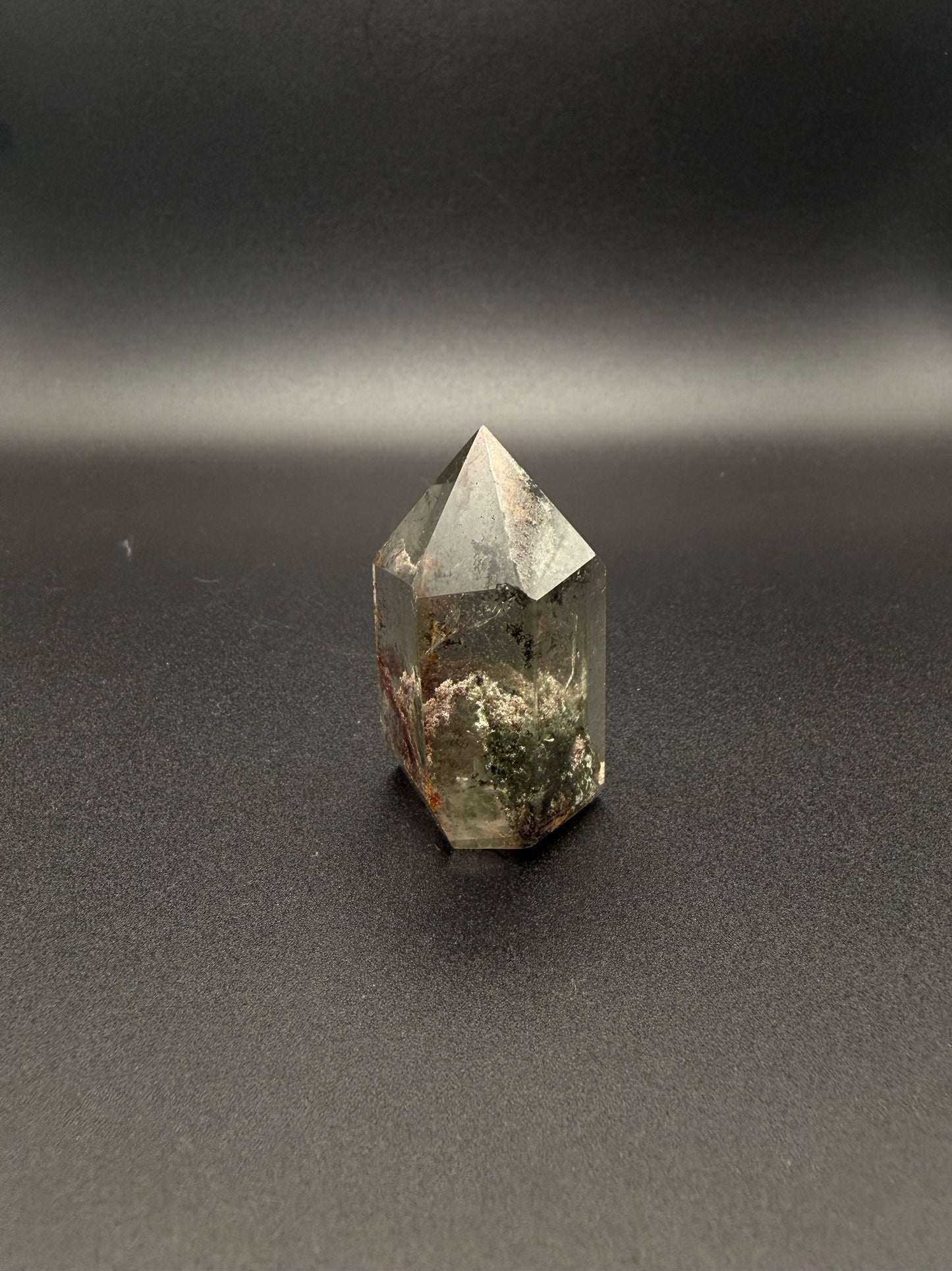 Polished garden quartz crystal tower with six sides.