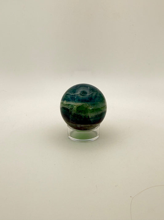 Rainbow Fluorite polished crystal sphere.
