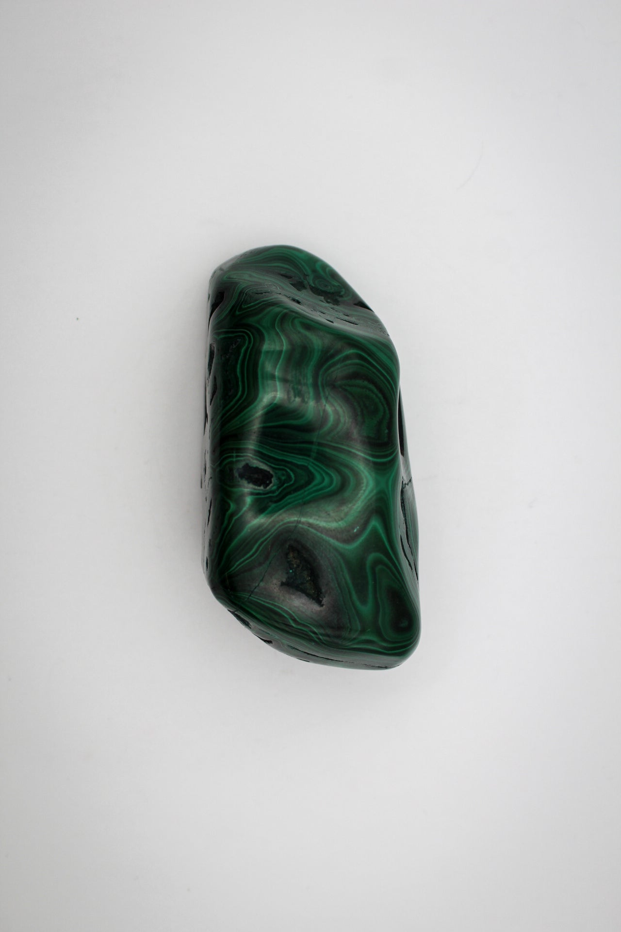 A vibrant green malachite free form with distinctive swirling patterns.