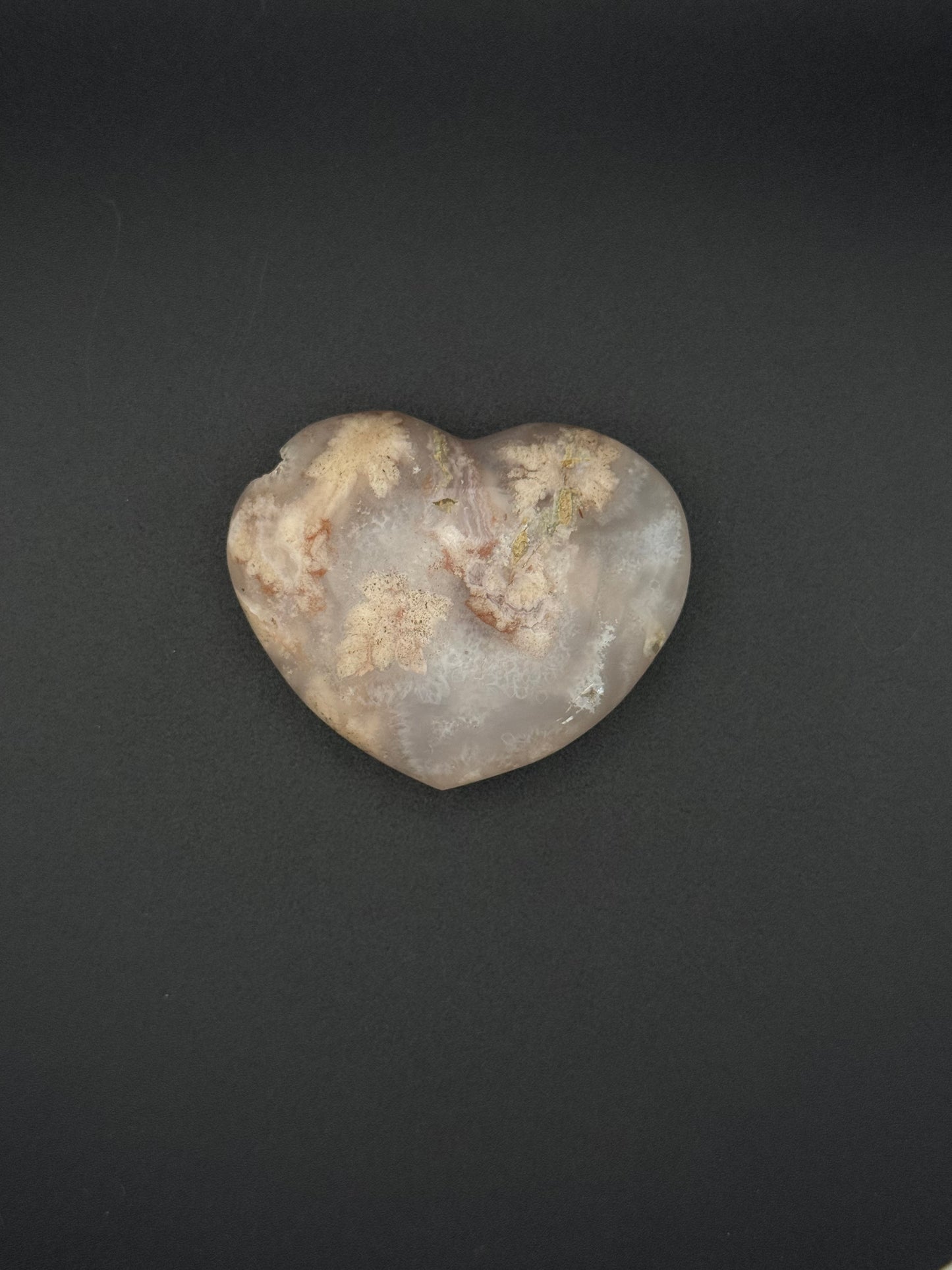 Heart-shaped polished flower agate crystal.