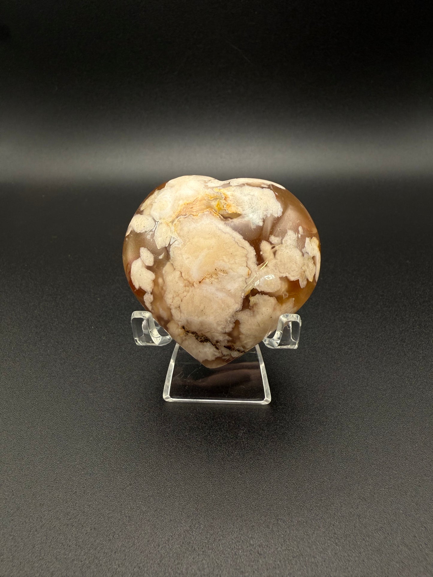 Flower Agate polished crystal in the shape of a heart.