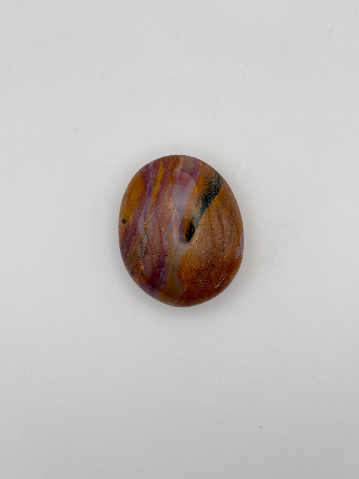 Polished ocean jasper palm stone.