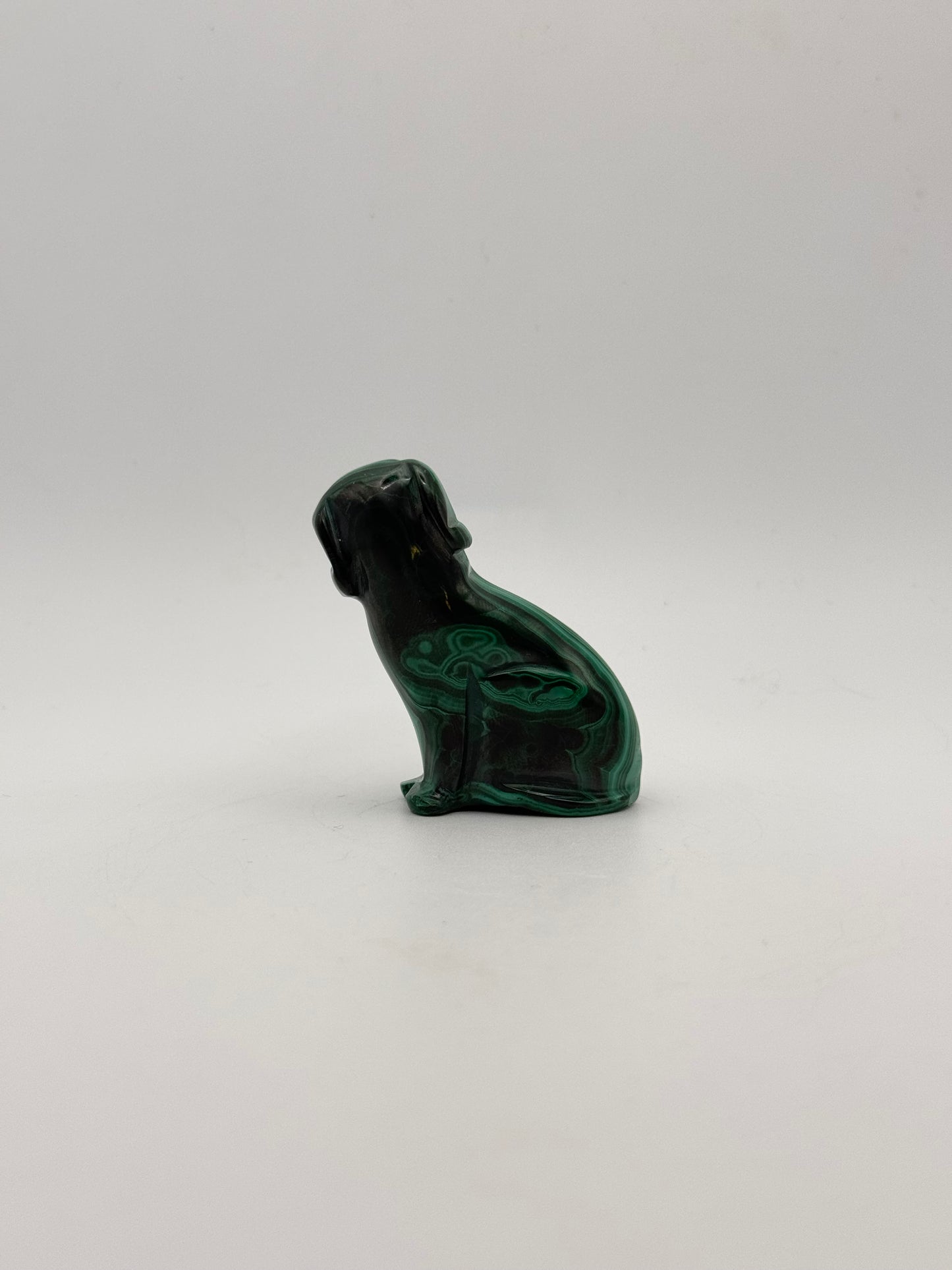 Polished malachite dog carving.