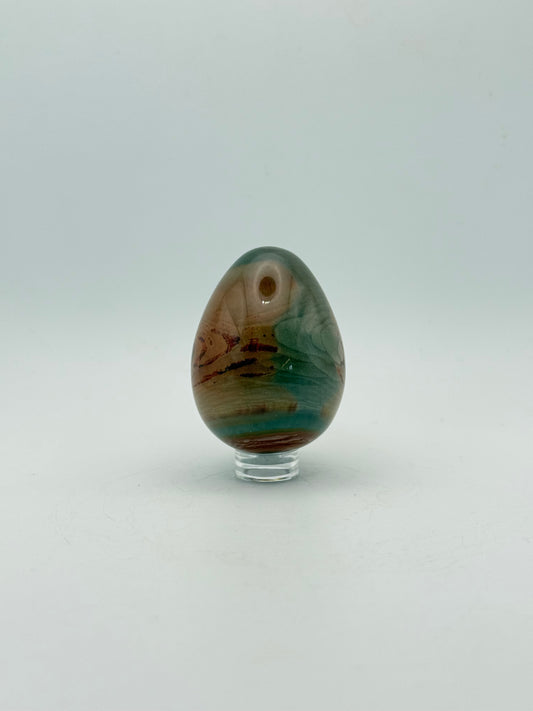 Polished polychrome jasper shaped into an egg.