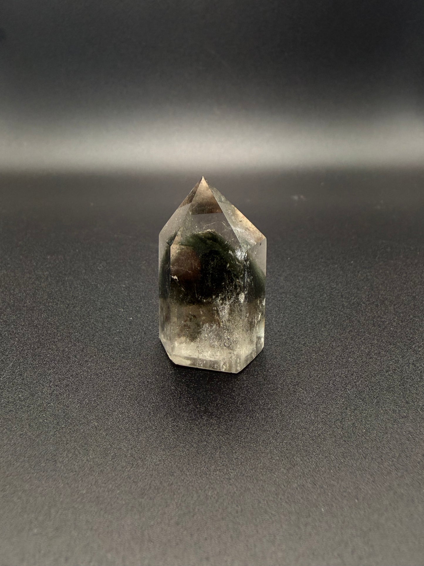 Polished garden quartz crystal tower with six sides.