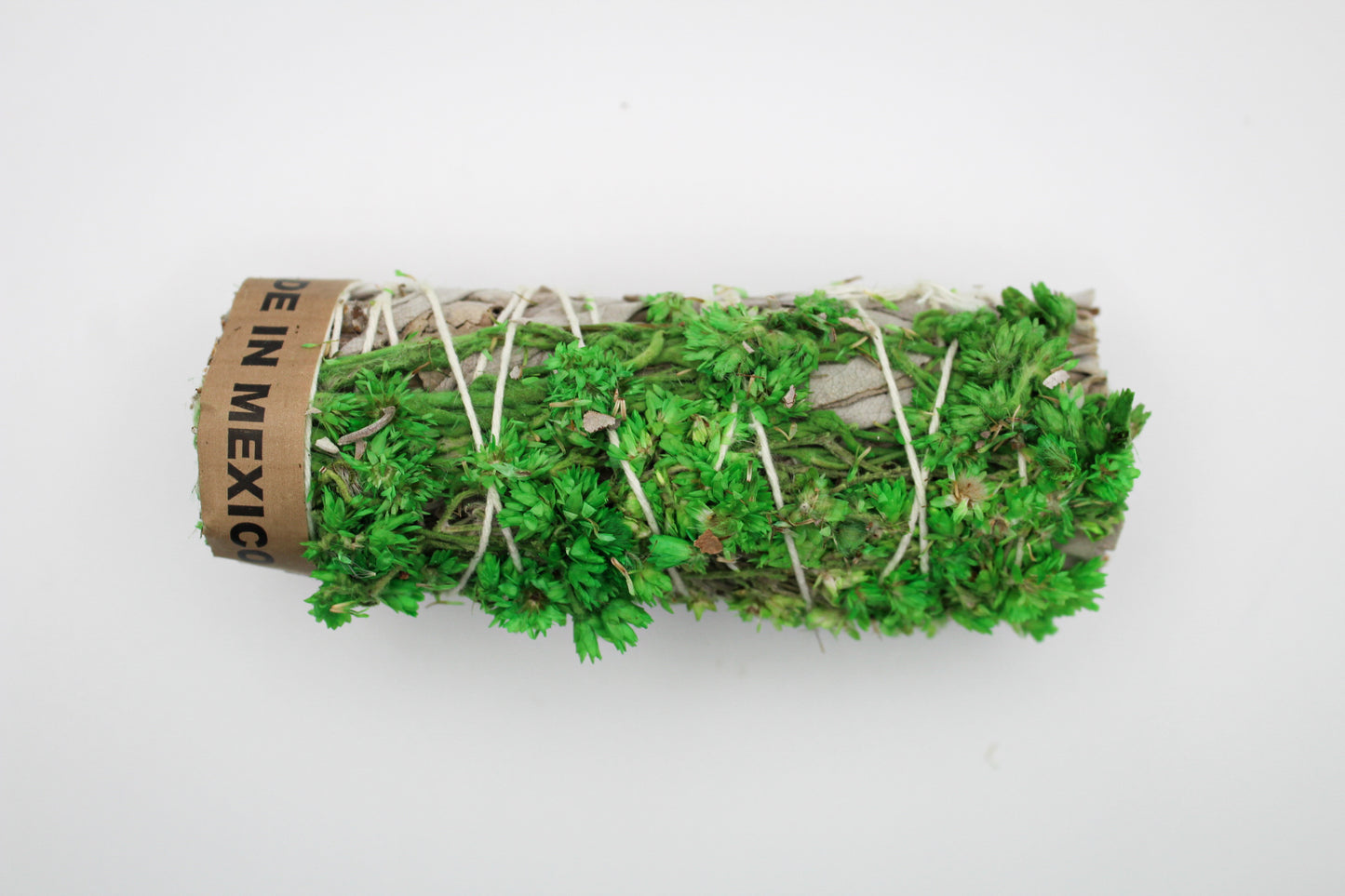 A bundle of sage with green flowers attached.