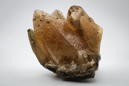 Raw dog tooth calcite crystal cluster.