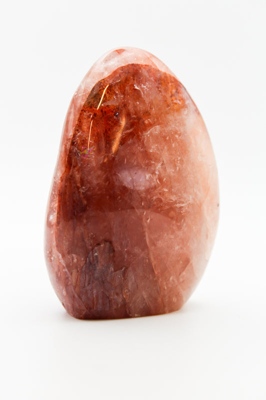 A polished red hematoid free form mineral.