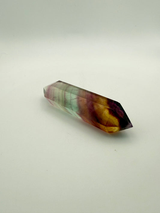Rainbow Fluorite polished crystal in the shape of a double term.