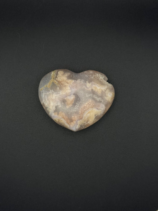 Heart-shaped polished flower agate crystal.