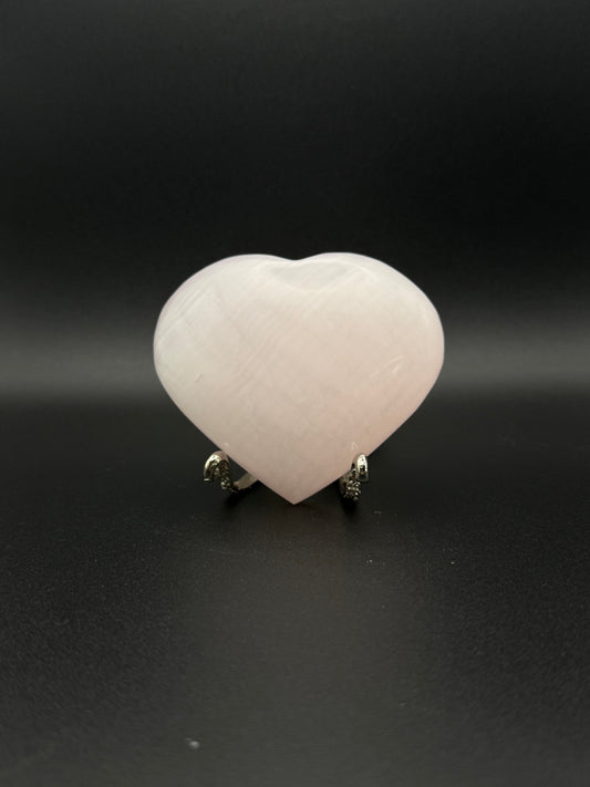 Polished pink calcite heart. Pink calcite glows under uv light.