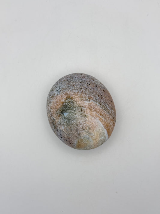 Polished ocean jasper palm stone.