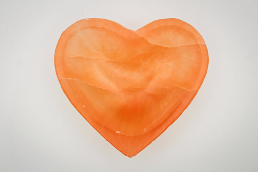Orange selenite heart shaped bowl.