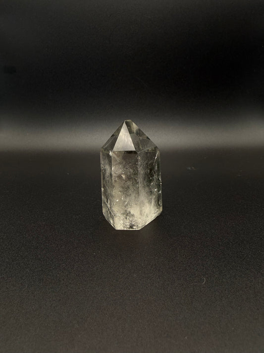 Polished garden quartz crystal tower with six sides.
