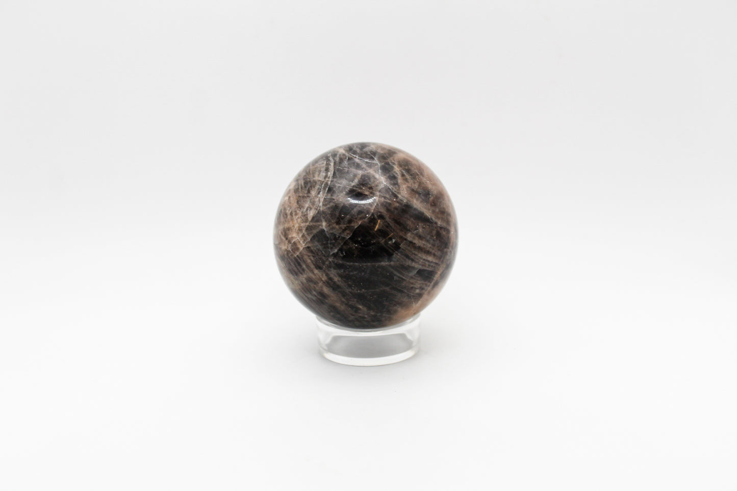 A polished black moonstone sphere.