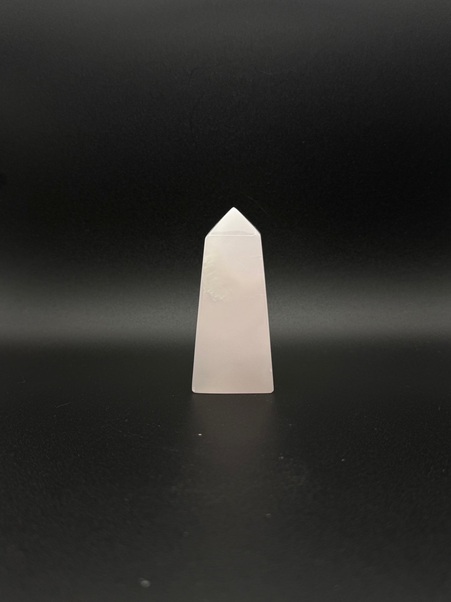 Polished pink calcite tower. Pink calcite glows under uv light.