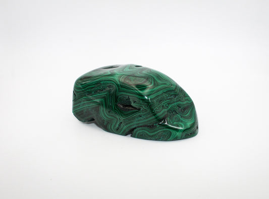 A vibrant green malachite free form with distinctive swirling patterns.