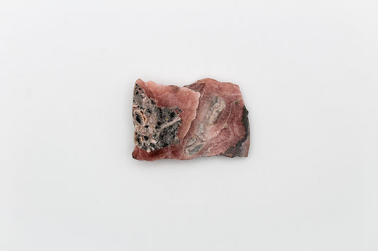 A polished rhodochrosite crystal slice.