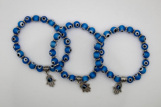 Blue colored evil eye bracelets with an evil eye charm.
