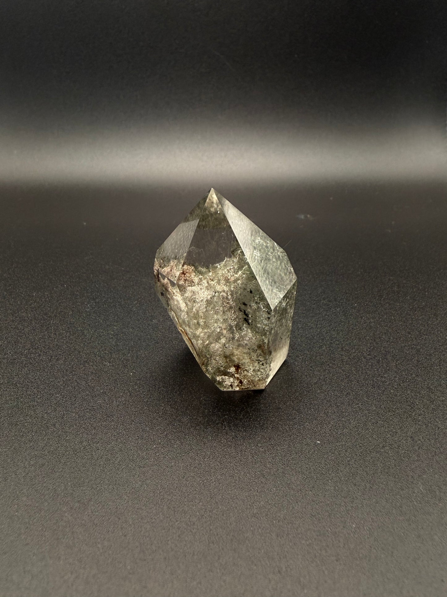 Polished garden quartz crystal tower with six sides.