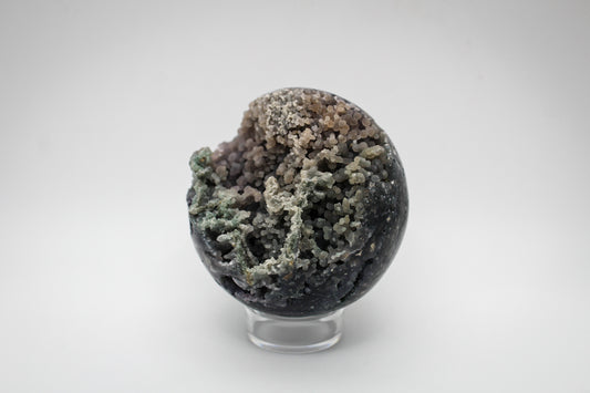 A spherical grape agate stone with a varied color pattern.