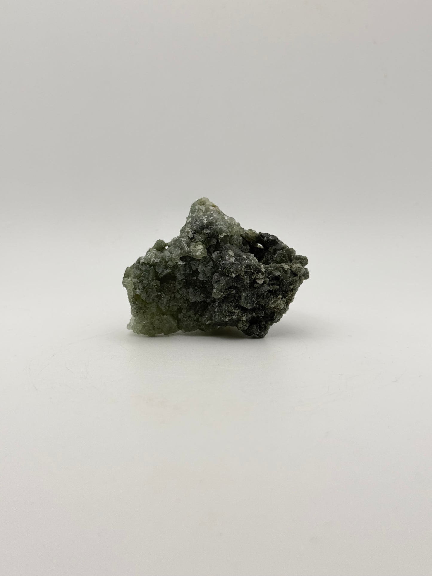 Raw prehnite specimen with good green coloring.
