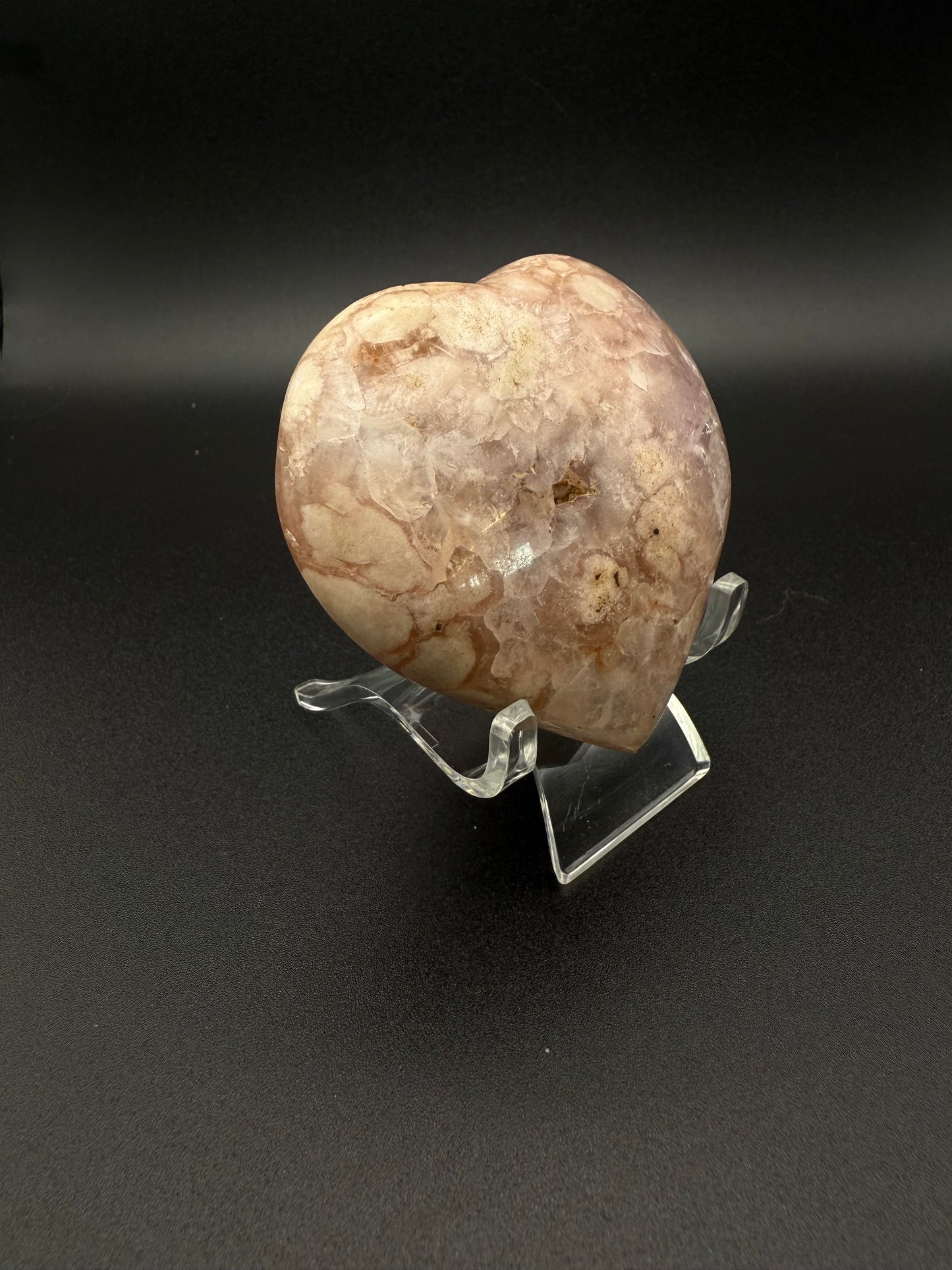 Flower agate polished crystal in the shape of a heart.