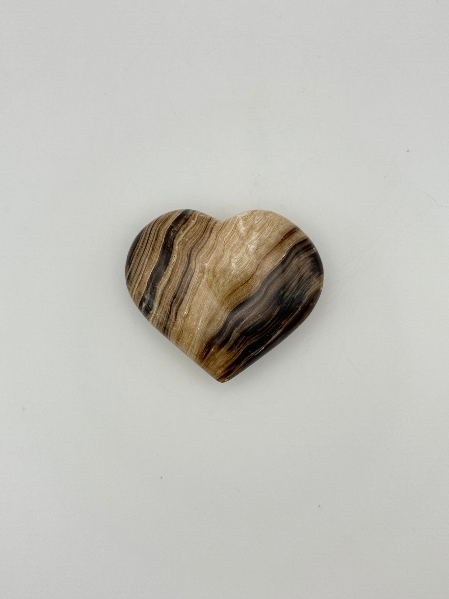 Polished chocolate calcite heart shaped crystal.