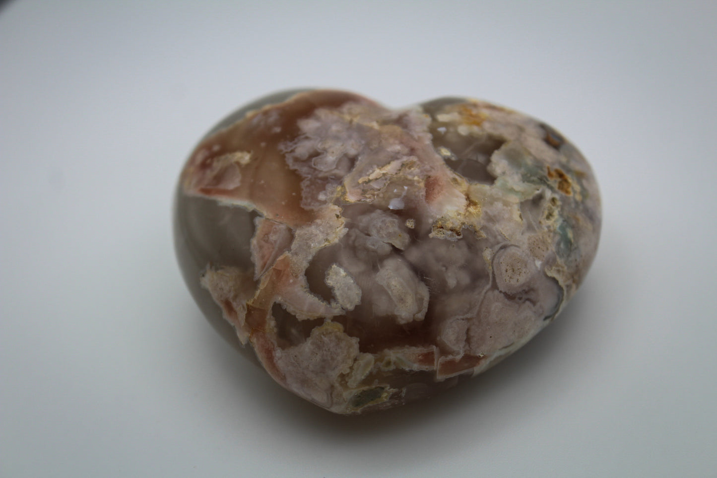 Polished flower agate in the shape of a heart.