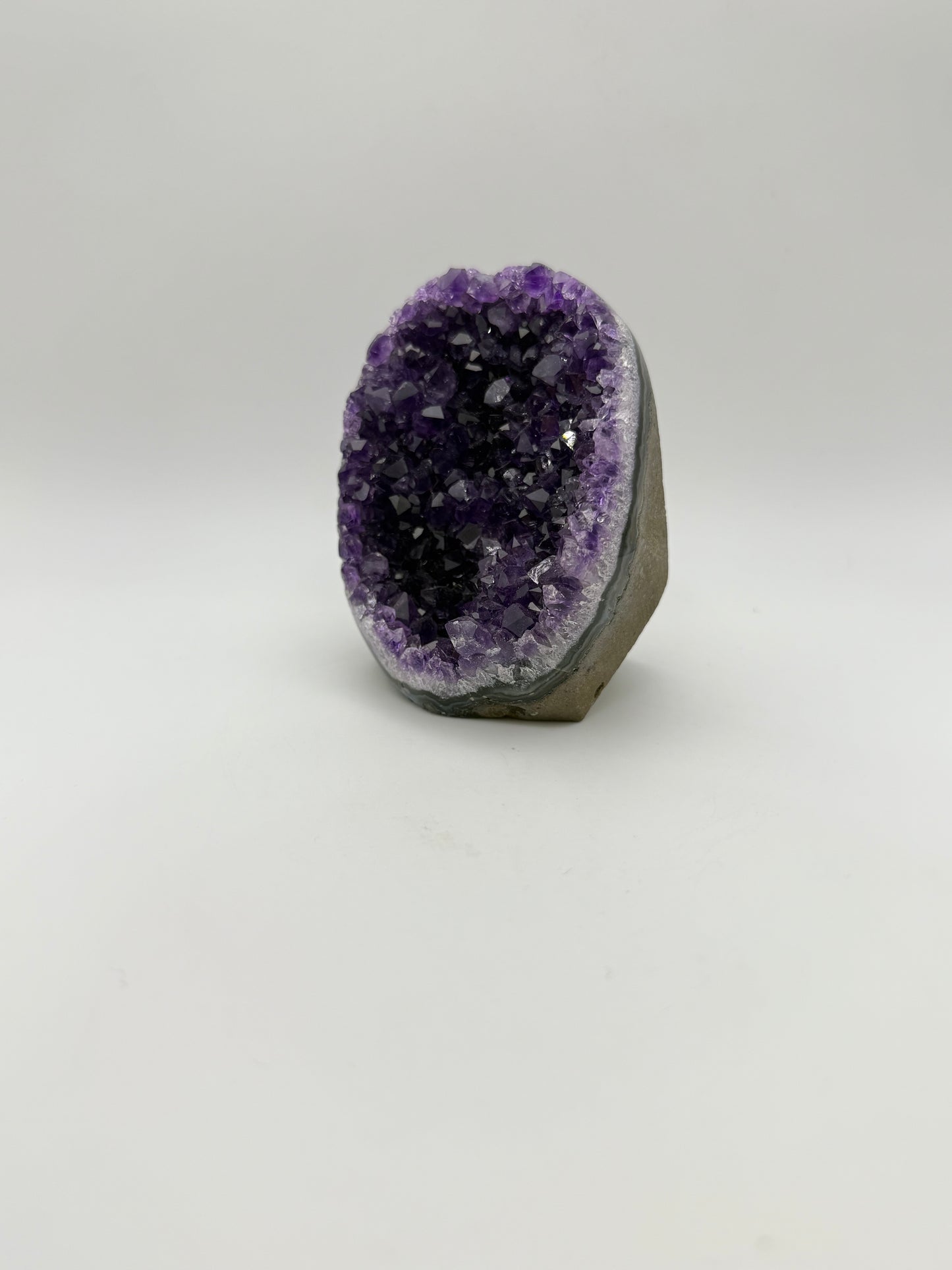 standing Amethyst cluster with deep purple crystals. about 3 1/2inches tall.