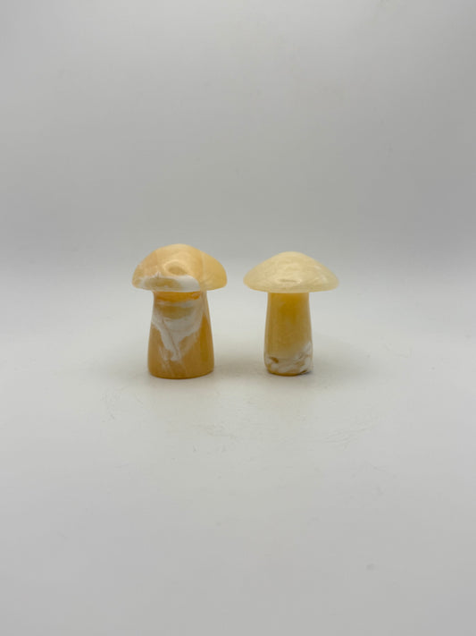 Two orange calcite mushrooms.