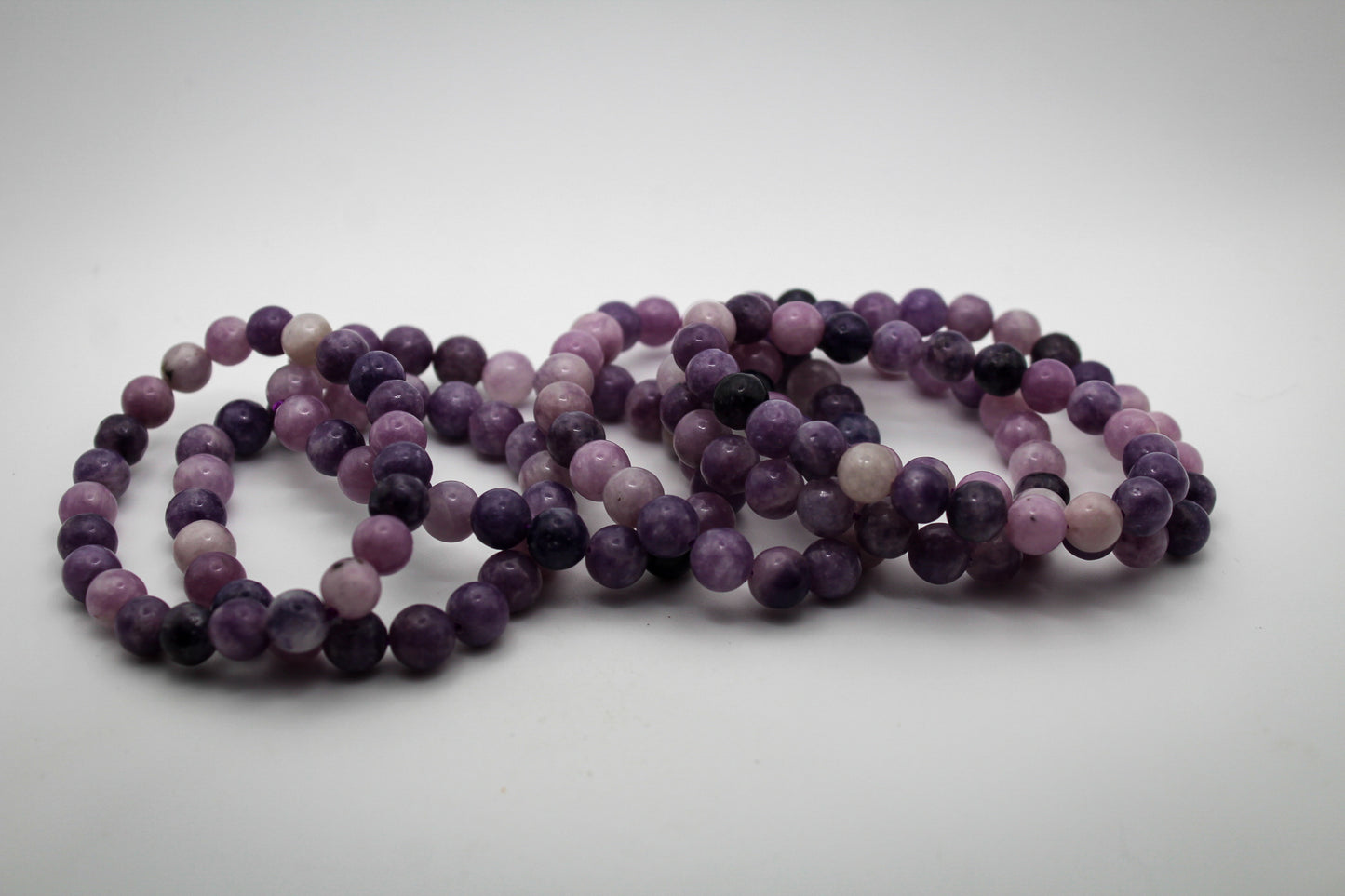 A bracelet made of purple lepidolite gemstone beads that are 8mm.