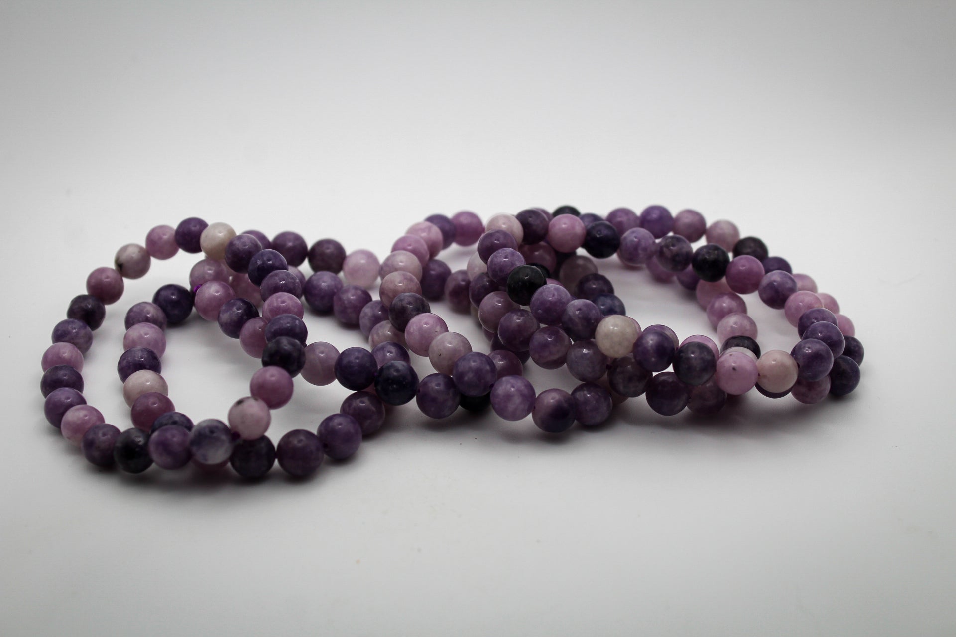 A bracelet made of purple lepidolite gemstone beads that are 8mm.