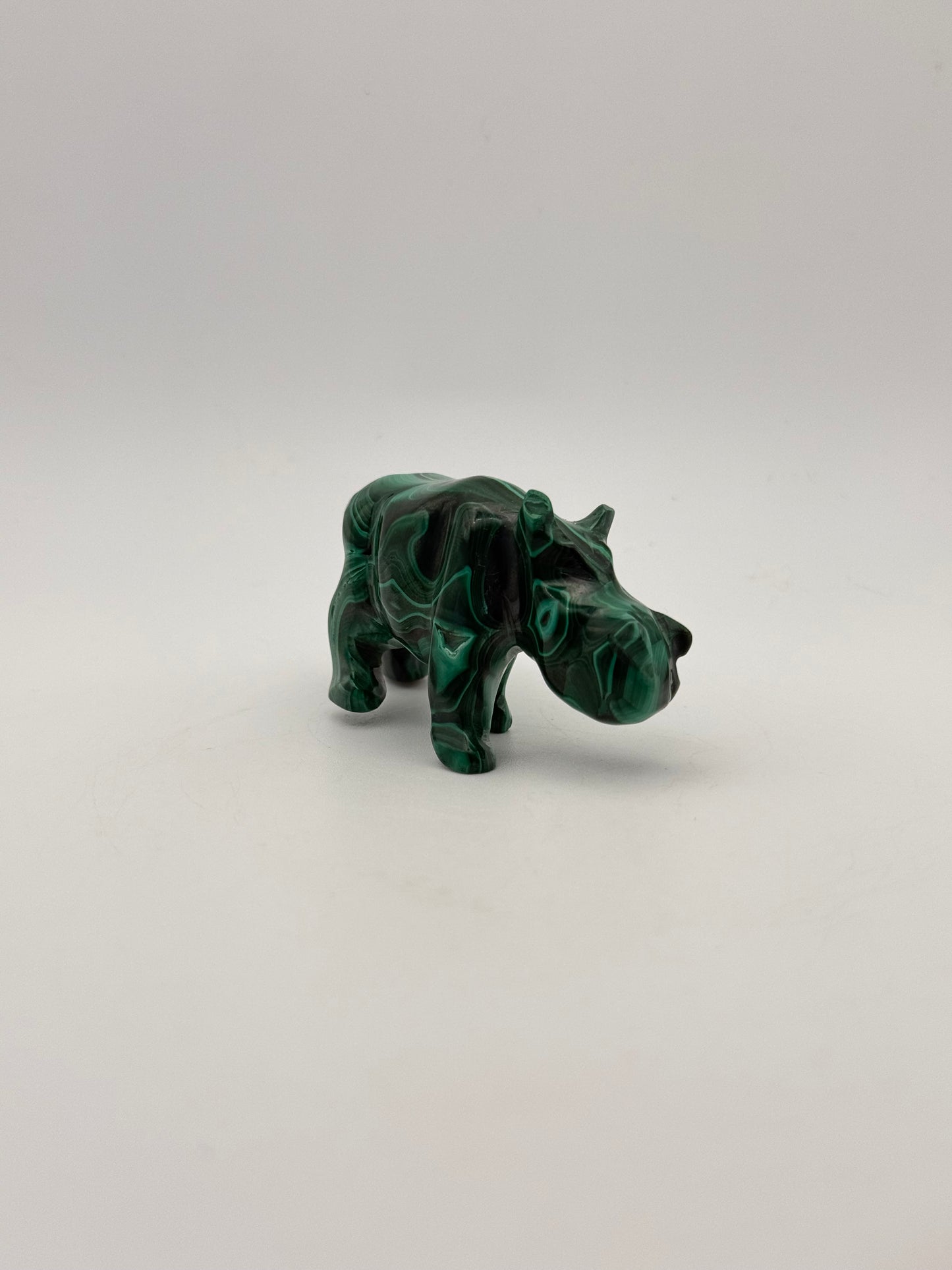Vibrant green malachite stone carving of a rhino.