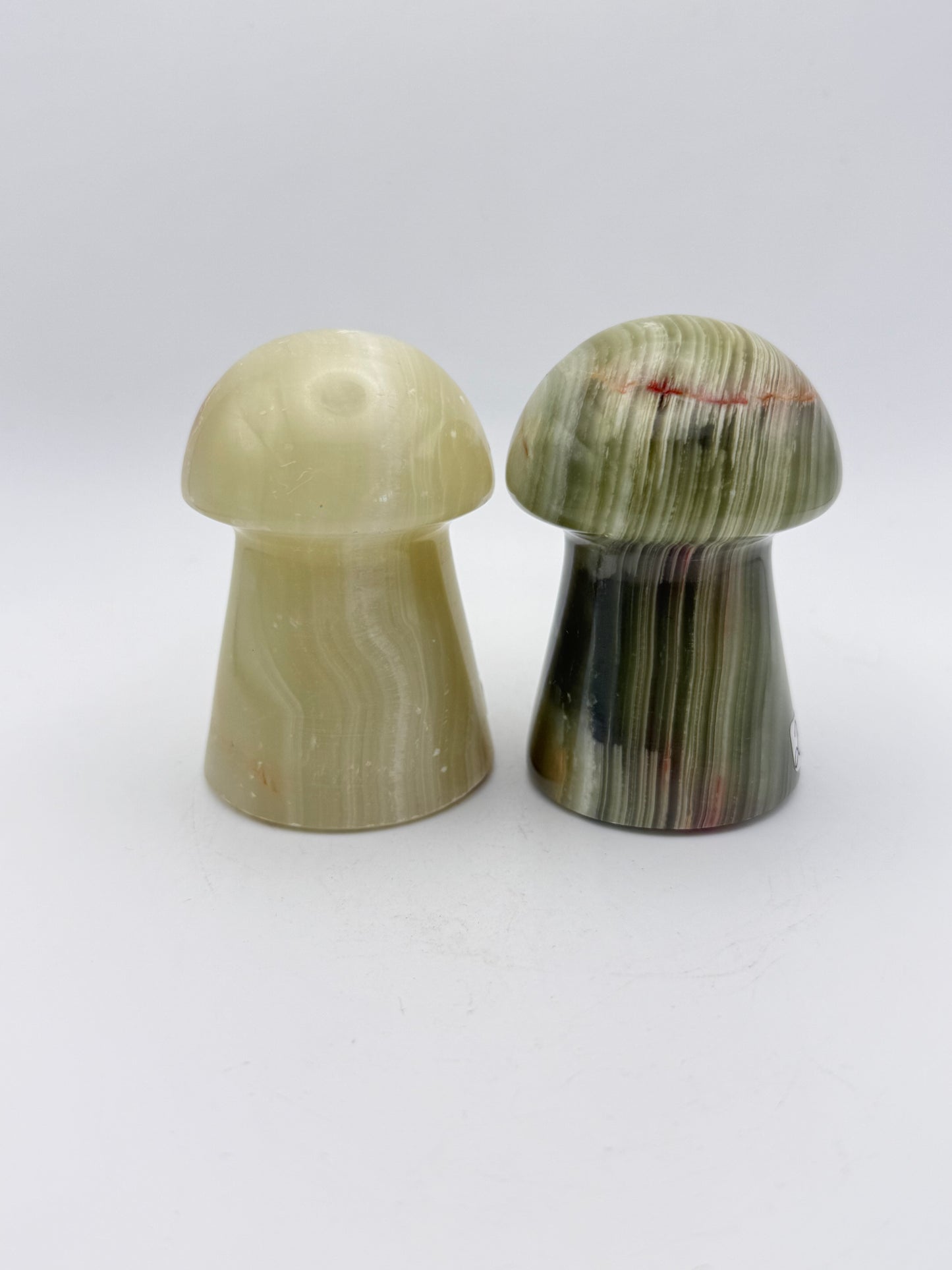 Two onyx mushroom-shaped stones.