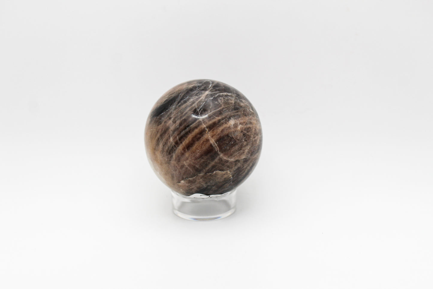 A polished black moonstone sphere.
