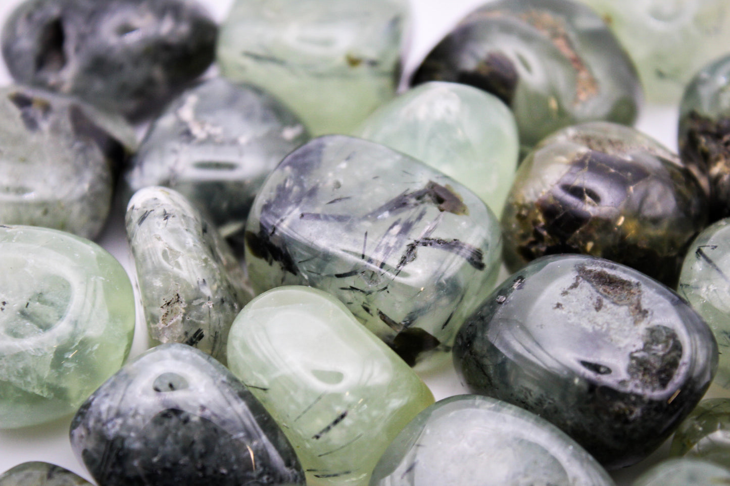 Assortment of prehnite tumbles.