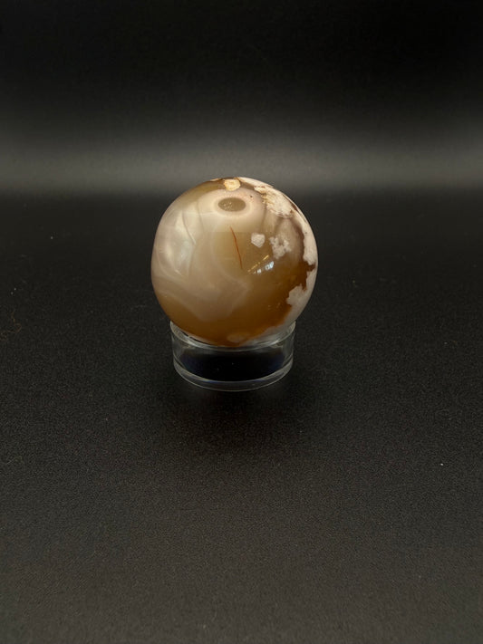 Flower agate polished crystal in the shape of a sphere.