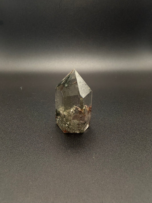 Polished garden quartz crystal tower with six sides.