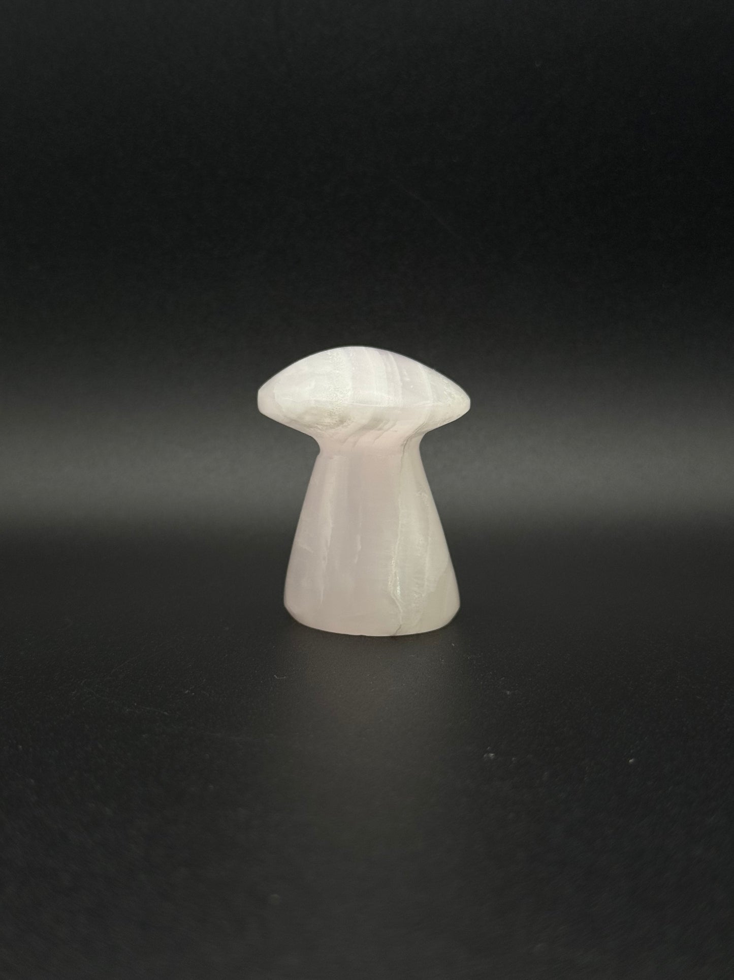 Polished pink calcite mushroom. Pink calcite glows under uv light.