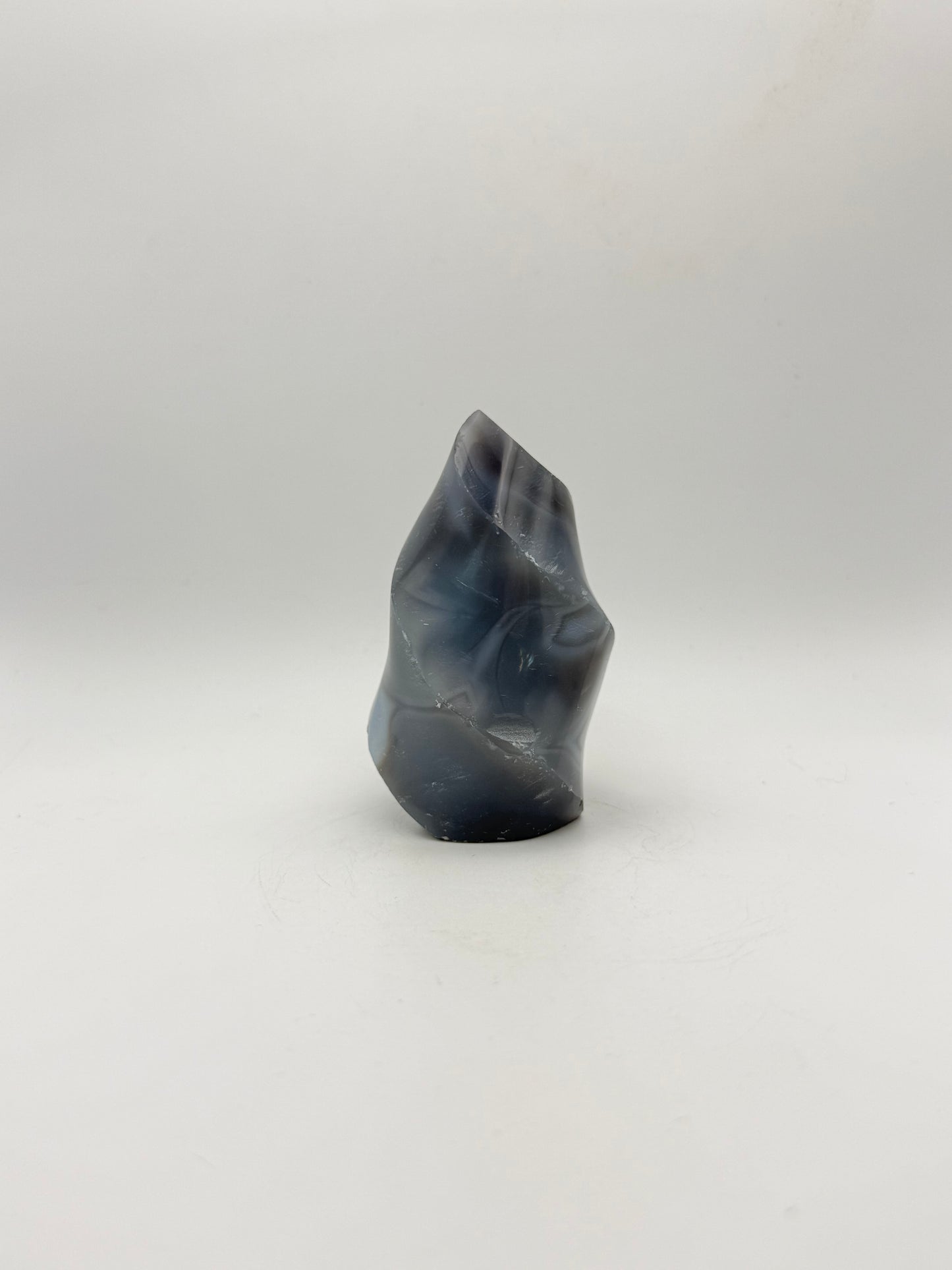 Polished orca agate in the shape of a flame.