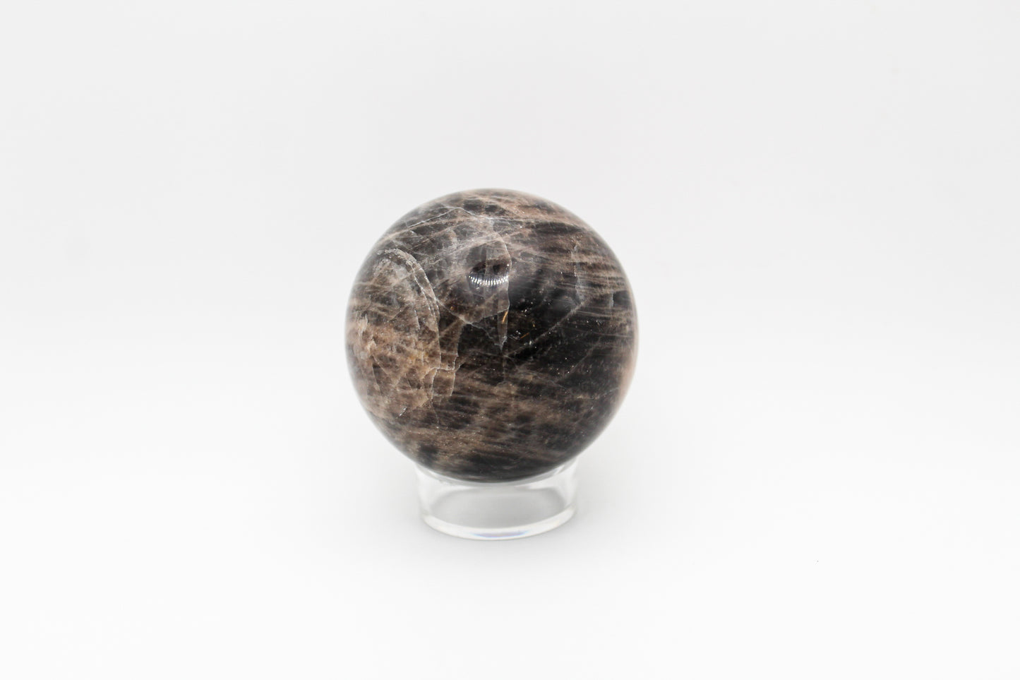 A polished black moonstone sphere.