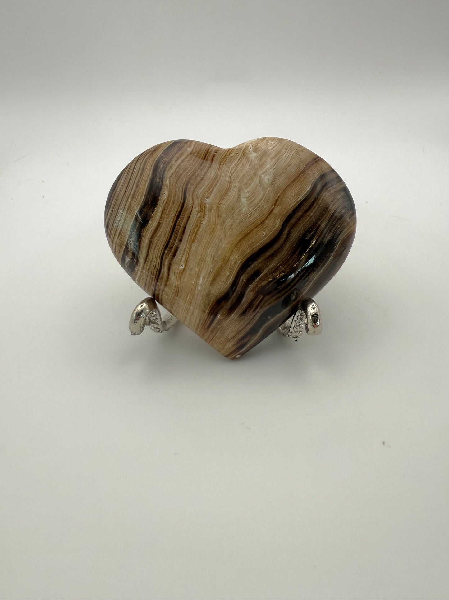 Polished chocolate calcite heart shaped crystal.