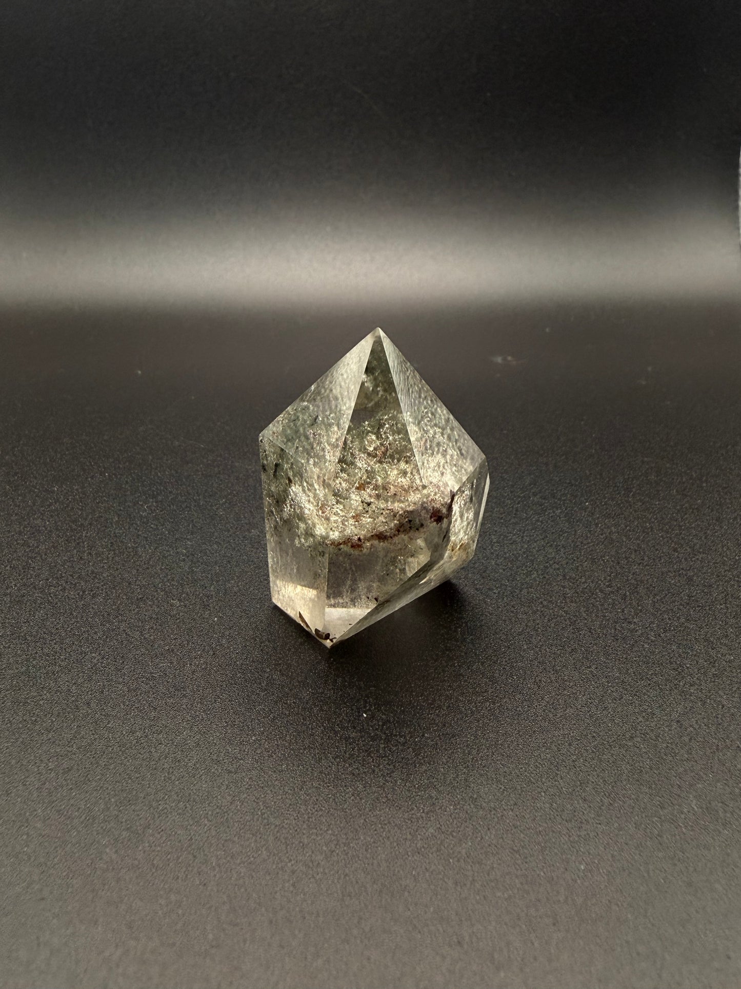 Polished garden quartz crystal tower with six sides.