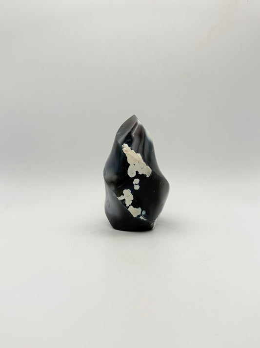 Polished orca agate in the shape of a flame.