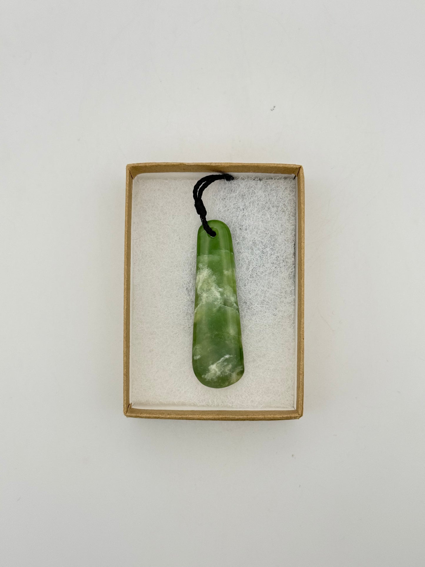Green Jade pendant with string necklace.