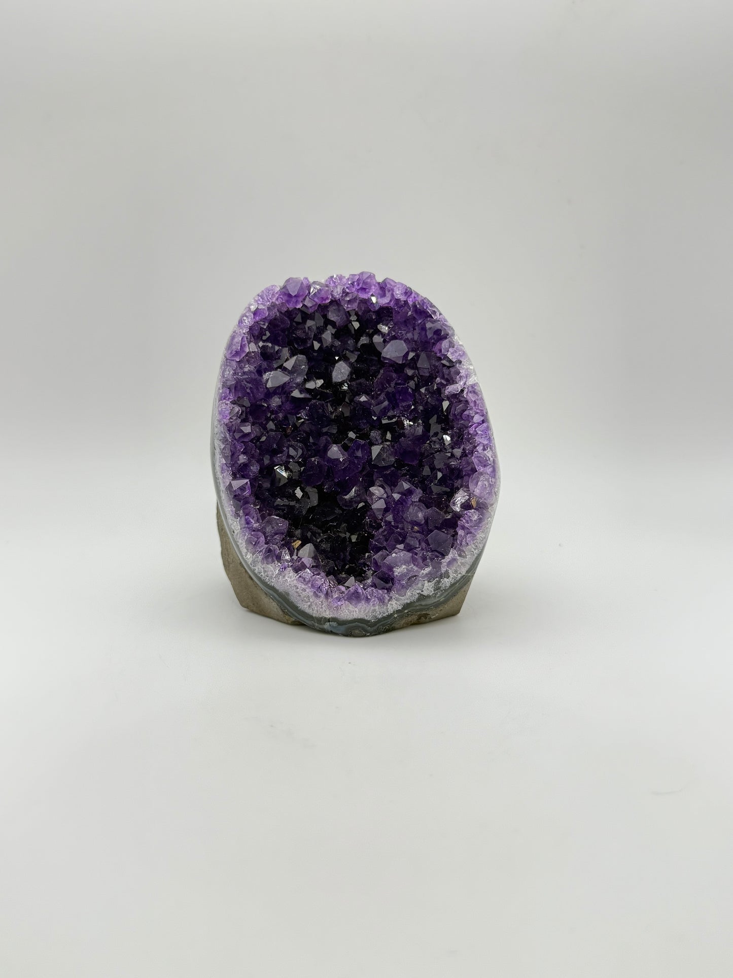 standing Amethyst cluster with deep purple crystals. about 3 1/2inches tall.