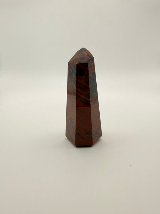 Polished mahogany obsidian tower with six sides.