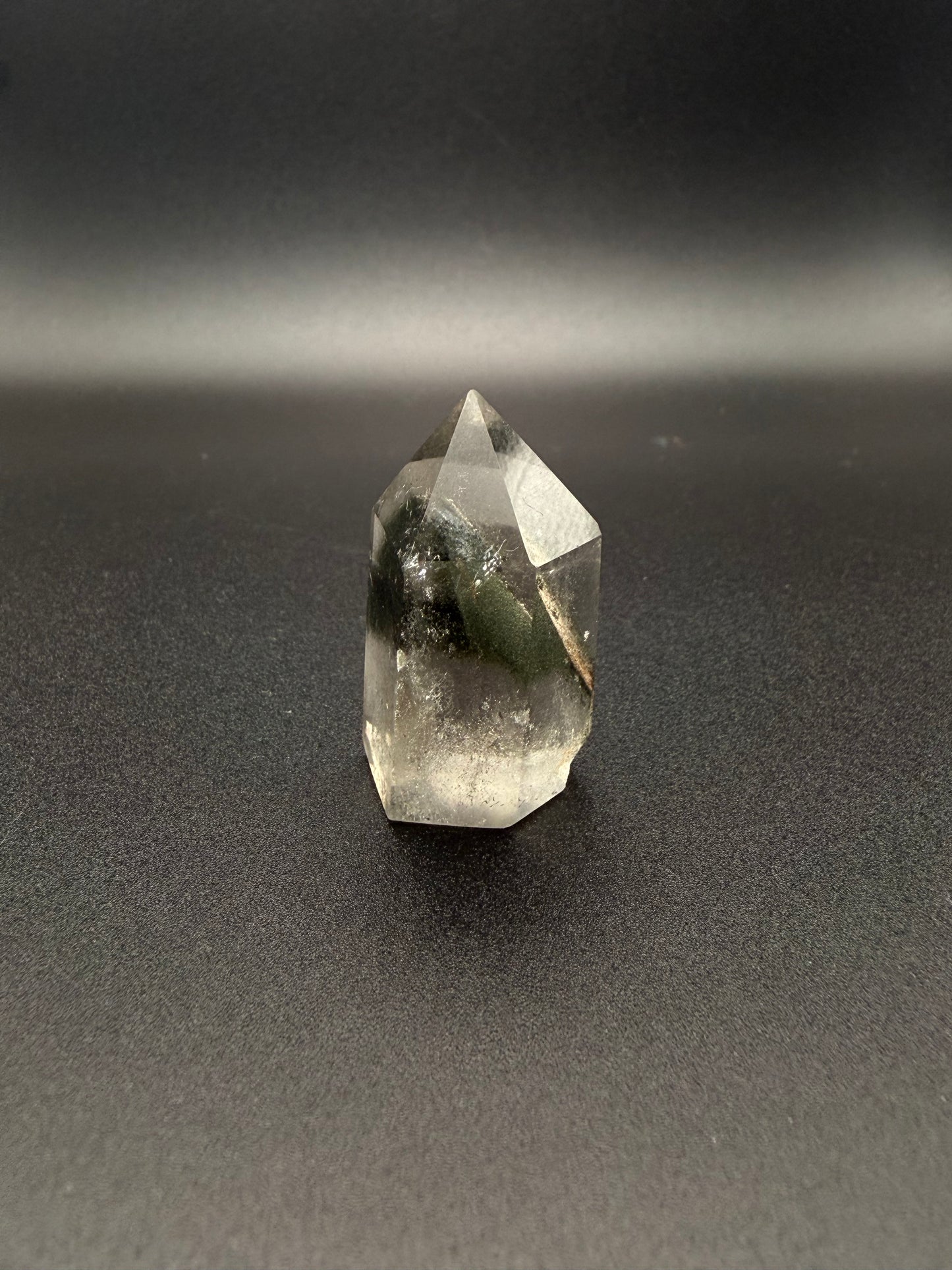 Polished garden quartz crystal tower with six sides.