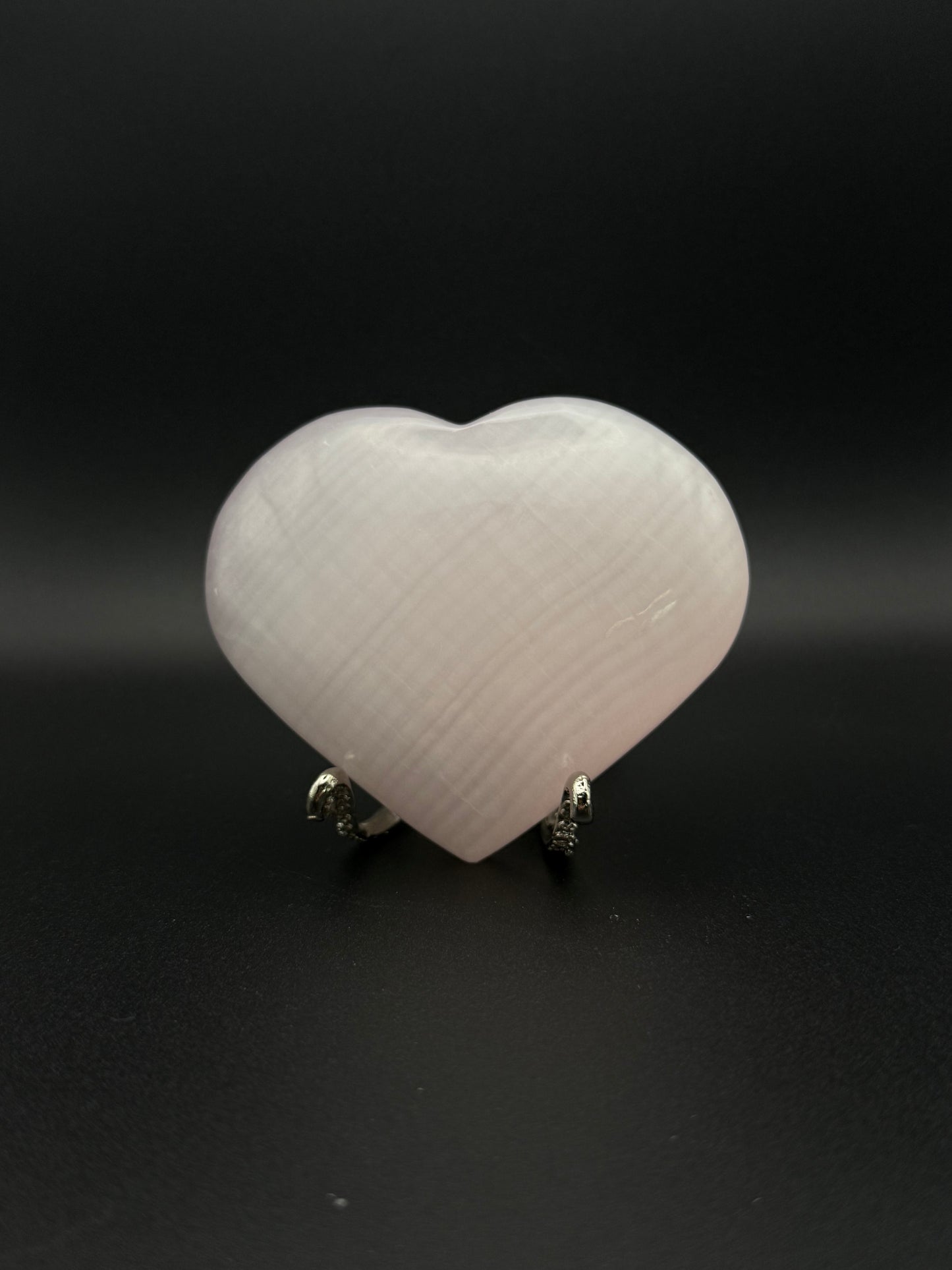 Polished pink calcite heart. Pink calcite glows under uv light.